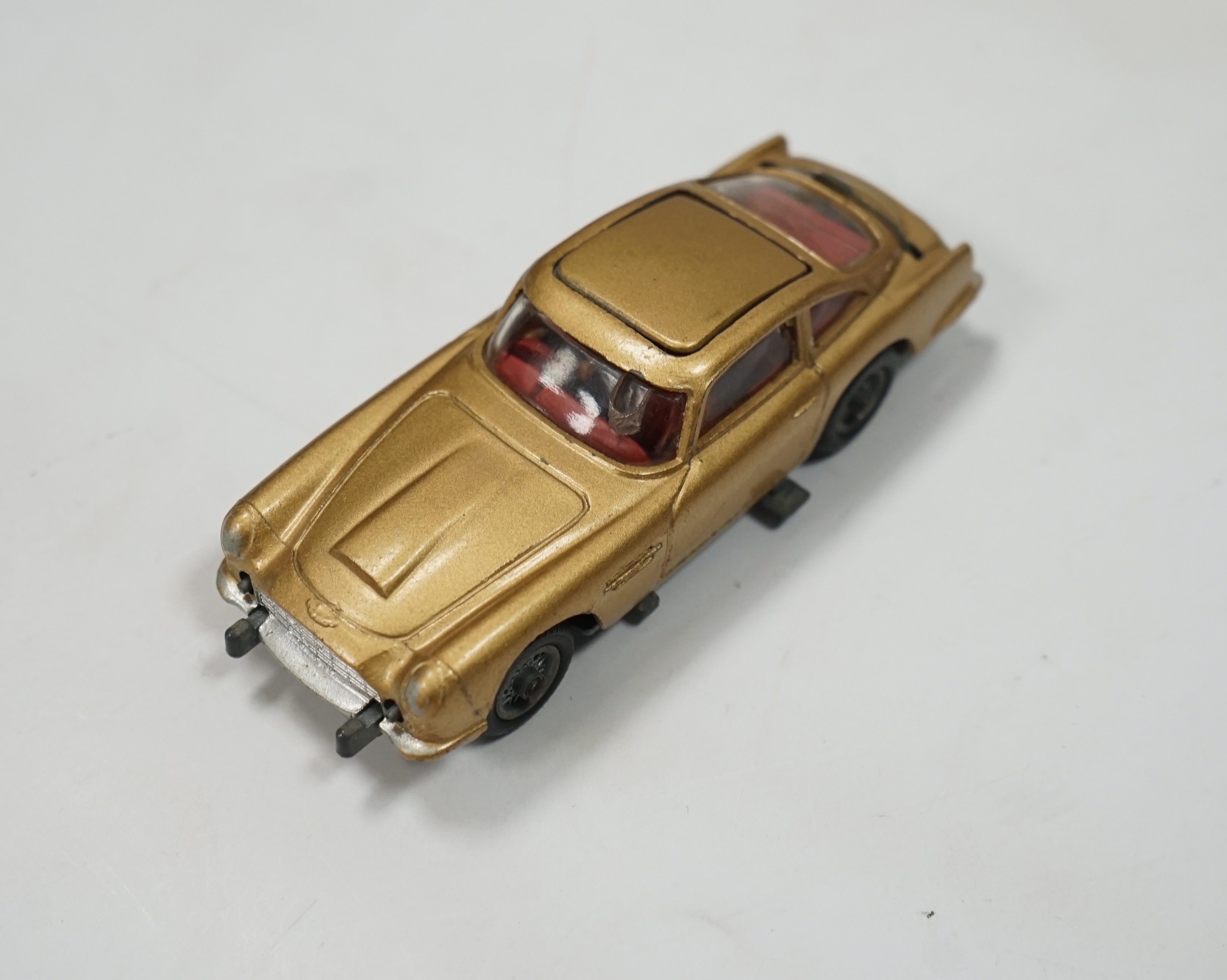 A boxed Corgi Toys James Bond 007 Aston Martin DB5 (261), a gold Aston Martin, with inner display stand, the envelope for the secret instructions (contents missing), the correct James Bond advertising leaflet and two pas